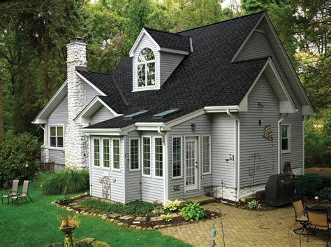 dark grey house with black metal roof|grey houses with black shutters.